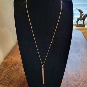 Long gold tone bar pendant